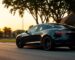 Stylish Tesla parked in a scenic neighborhood at sunset.