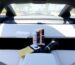 Sleek Tesla interior, cleaning supplies, shiny exterior.