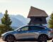 Tesla with roof tent in mountains.