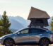 Tesla with roof tent in mountains.