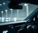 Close-up: sleek Tesla interior, glowing dashboard.