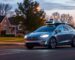Tesla robotaxi driving on a road.